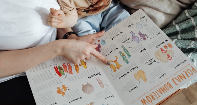 A comforting moment of a mother reading a colorful picture book with her child.